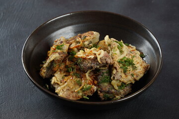 Fried beef liver with fried onions and herbs