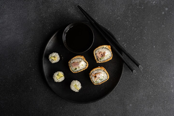 Fried sushi and avocako maki on the plate