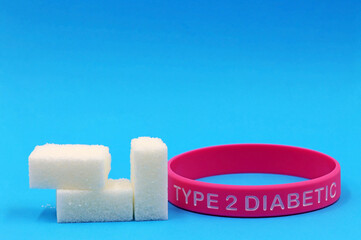 Sugars next to a diabetic bracelet. Concept of sugar consumption and diabetes