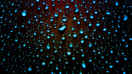 Water drops in neon lighting. Abstract background with colorful texture backdrop