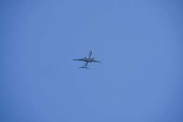 Shot of a jet plane high in the blue skies.