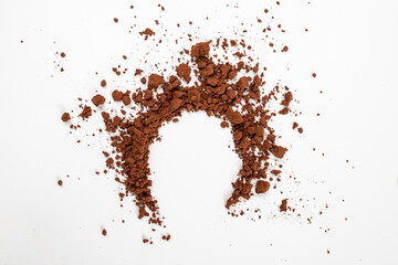 circle shaped cocoa powder spilled and scattered , close up  on white