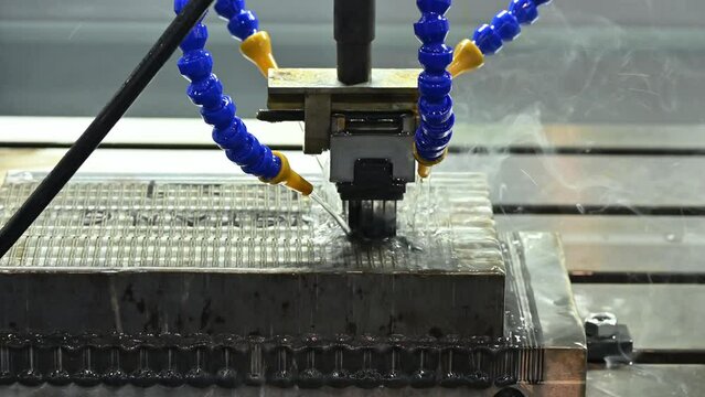The EDM machine operation with liquid coolant method.