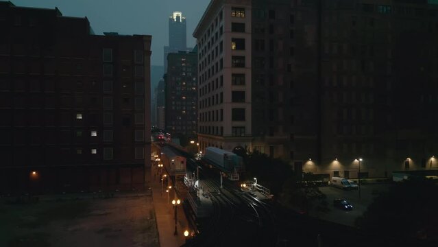 Train passing on Elevated Track at Night time. Subway in downtown Chicago. Drone night shot