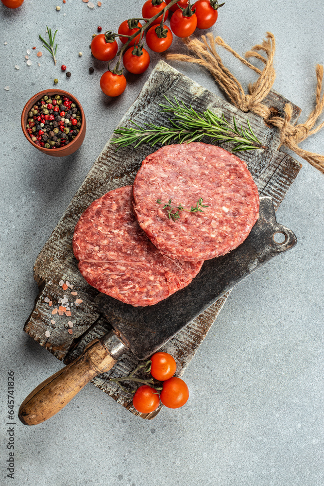 Wall mural Raw veal mince Burger steak cutlets on a light background, Restaurant menu, dieting, cookbook recipe top view