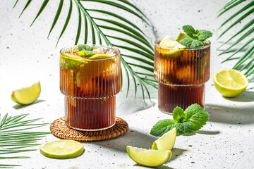 Cuba Libre with rum, cola, mint and lime in the glass. banner, menu, recipe place for text, top view