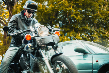 male motorcyclist on a custom chopper motorcycle wearing a helmet.