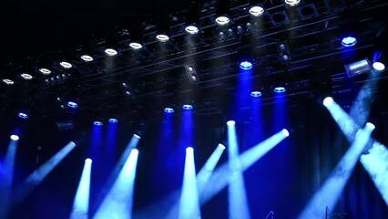 stage ceiling light lightning and flashing, bright blue spotlights on a musical stage during concert or show