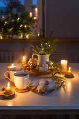 two cups of tea with homemade christmas baked goods on kitchen with christmas decoration