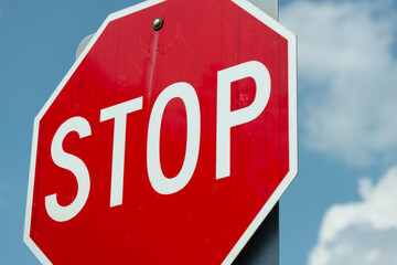 stop sign on a cloudy blue sky