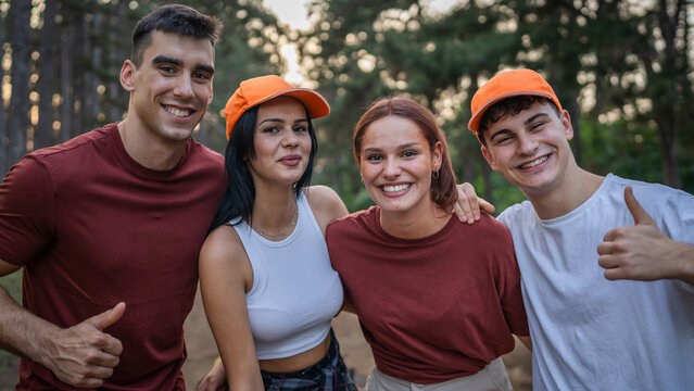portrait of group of friends volunteers prepare to collect garbage waste and clean forest nature in summer day slow motion