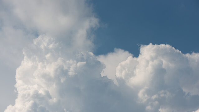 billowing clouds meet cottony clouds and blue sky © eugen