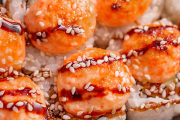 Sushi rolls baked with sesame seeds, close-up, selective focus