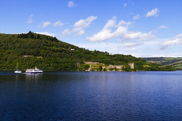 Fototapeta na wymiar Sailing Through Legends: Passenger Ship En Route to Urquhart Castle on Loch Ness