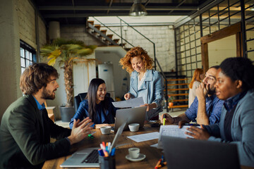 Young and diverse group of designers having a meeting in an office while working in a startup company
