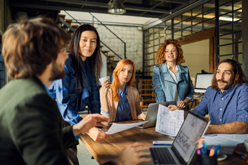 Young and diverse group of designers having a meeting in an office while working in a startup...