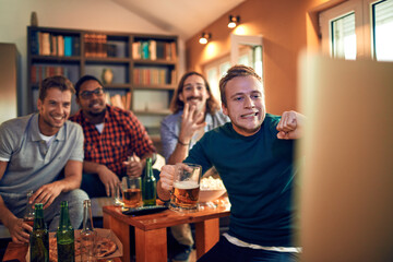 Young and diverse group of friends getting nervous during an intense soccer or football match on tv
