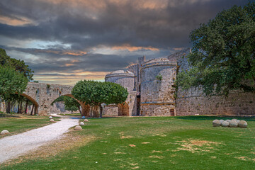 Fortress Walls and inner courtyard at Palace of the Grand Master of the Knights in Rhodes, Greece - 645753445