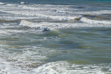 Rolling long waves in sea on seashore, close-up
