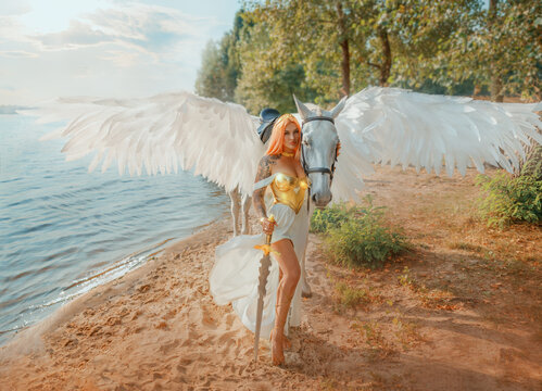 Art photo real people Fantasy woman warrior queen hand strocking white horse with wings pegasus animal. goddess girl sexy princess holds magic sword in hands. summer nature water river sea lake river