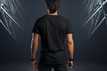 Black tee with back design showcased on a fashionable young man