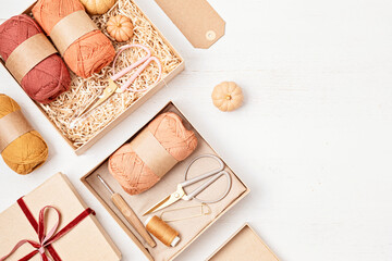 Preparing gift box for knitting lovers. Plastic free zero waste care package. Personalized eco friendly basket for family and friends for autumn holidays, christmas, mothers day