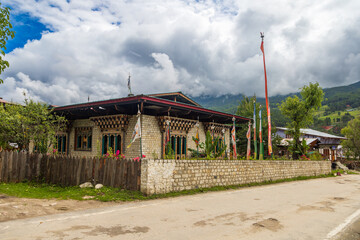 Scenic view of a building with clouds and mountains in the background in Bumthang valley in Bhutan.