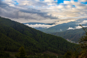 Fototapeta na wymiar Beautiful view of a valley with trees and mountains in Bhutan, scenic panorama mountain summer landscape