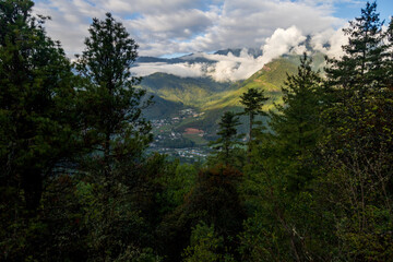Beautiful view of a valley with trees and mountains in Bhutan, scenic panorama mountain summer landscape