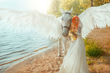 Art photo real people Fantasy woman royal queen hand strocking white horse with wings pegasus animal myth elf girl sexy fairy princess white dress. summer nature water river sea lake divine sun light