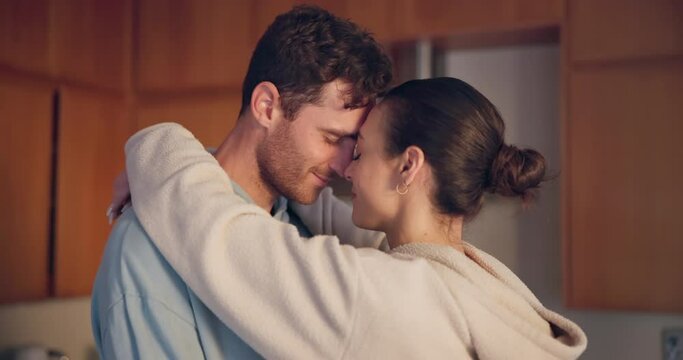 Couple, hug and forehead in kitchen, romance and intimate love with care, bonding and happy for connection. Young man, woman and together with embrace, memory or anniversary in profile, date and home