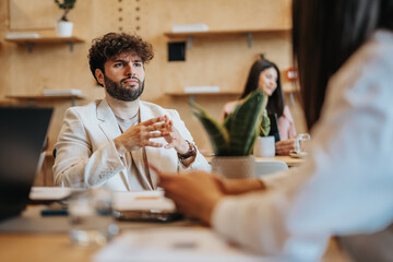 Handsome businessman in coffee shops brainstorming ideas for his next business venture, eager to make his mark on the world.