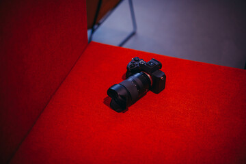 Camera placed on red sofa background