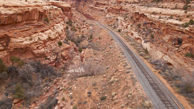 Aerial shot of railroad tracks running through the amazing rock formations near Moab, Utah, USA.