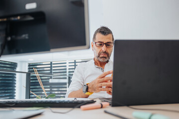 Businessman working at the office, analyzing profit reports and teamwork results.