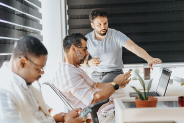 Successful Multigenerational Team Working in a Modern Office Conference Room