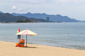 Awesome view of central beach of Nha Trang, Vietnam. Beautiful white sand tropical beach in coastal city. Scenic coastline. Amazing cityscape. Nha Trang is a popular tourist destination of Asia.