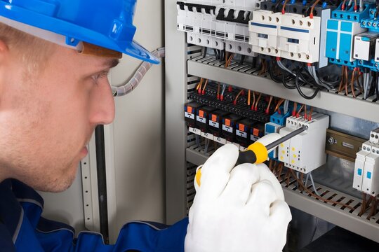 Male Electrician Examining Fusebox