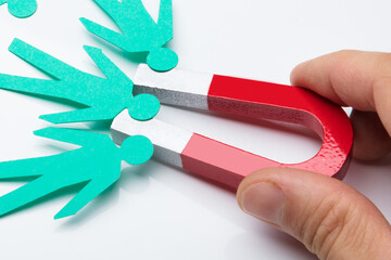 Person's Hand Holding Red Horseshoe Magnet
