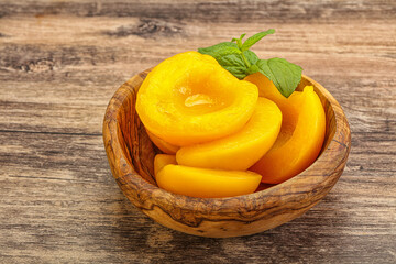 Sweet ripe canned peaches with mint