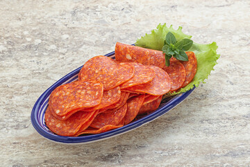 Sliced pepperoni sausage in the bowl