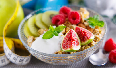 healthy breakfast- bowl of muesli with granola and fresh fruits
