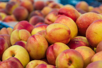 Sweet fruit. Peach on the market counter for sale.