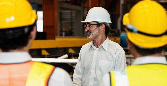 Collective factory worker and engineer gather for meeting with factory executive or manager, discussing plan and industry training program on-site work heavy industrial steel workshop. Exemplifying