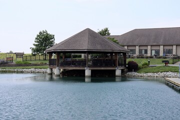 The old wood gazebo at the park on a sunny day.