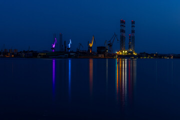 Cranes in the port illuminated by the giant port cranes of Pula

