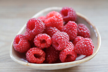 Delicious raspberries freshly picked from the bush in the home garden.