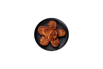 Fish cakes. Fish patties. Fried cutlets of minced fish on a black plate