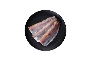 Delicious fresh herring fillet with salt, spices and herbs on a black plate