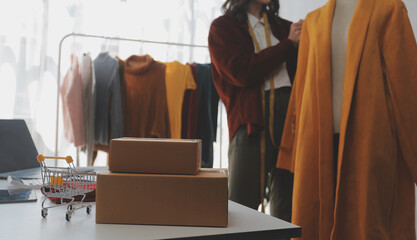 Portrait young attractive hipster asia female owner startup look at camera work happy with box at home prepare parcel delivery in sme supply chain, procurement, omnichannel ecommerce online concept.